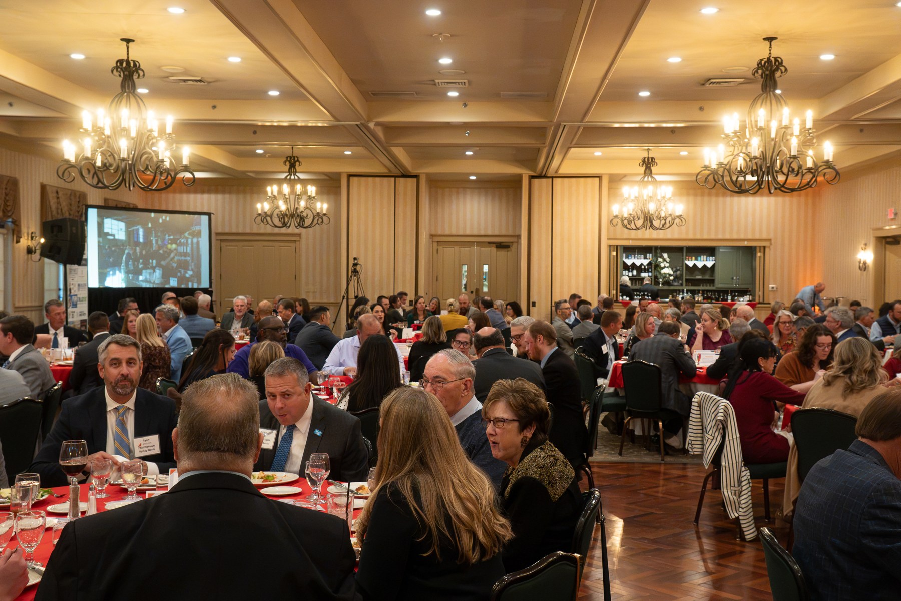 A wide view of the annual meeting room and audience