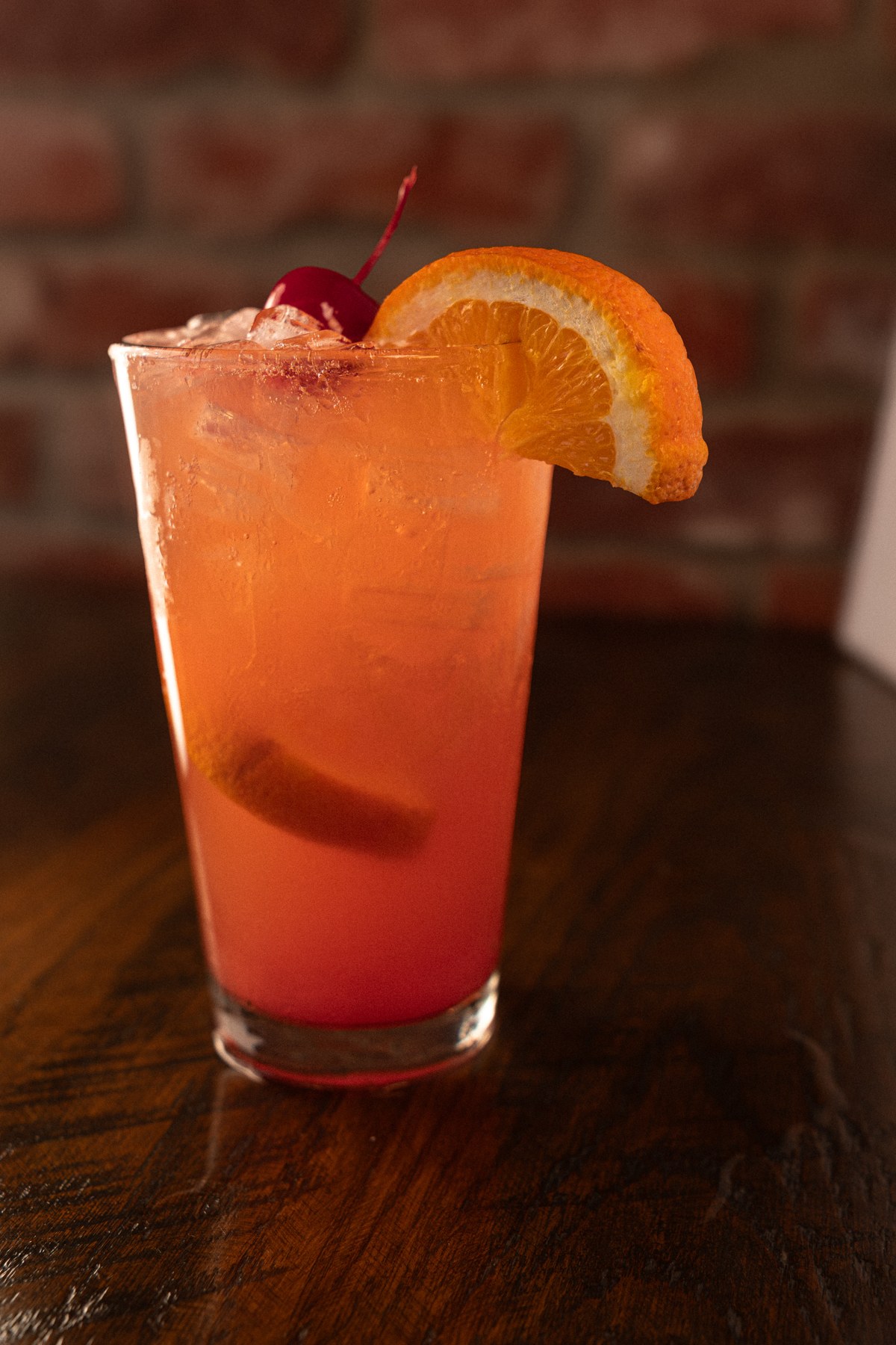 A cocktail garnished with an orange slice