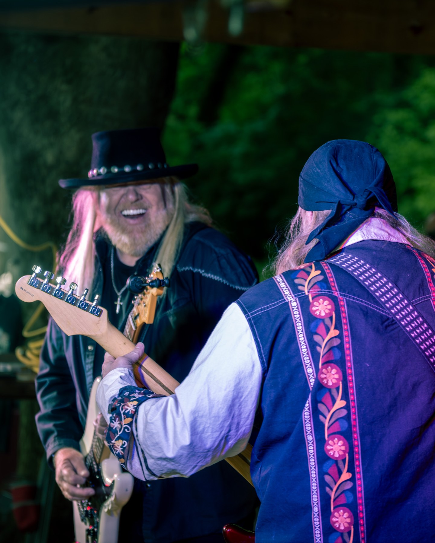 Two musicians performing together outdoors