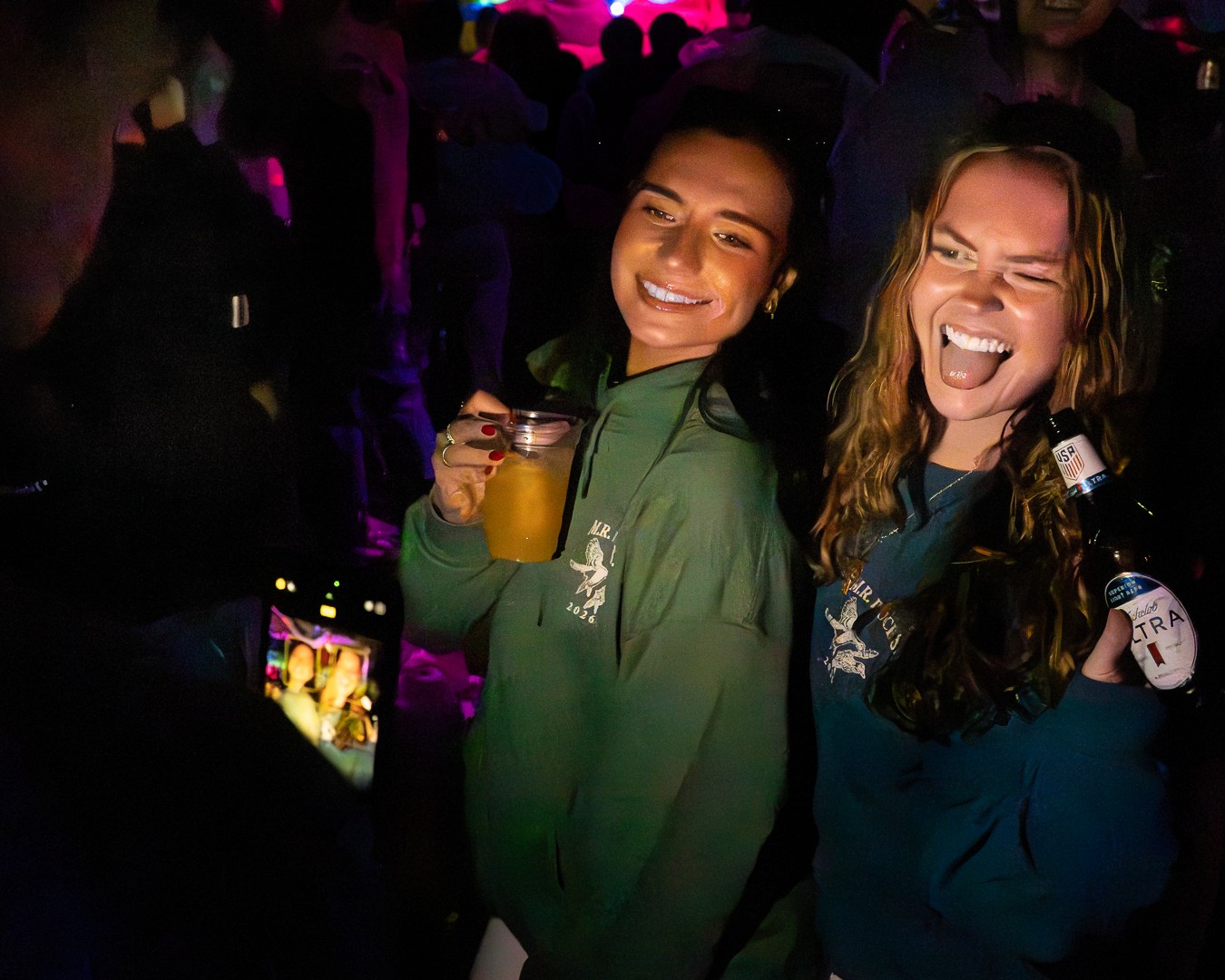 Friends sharing drinks in a dark venue