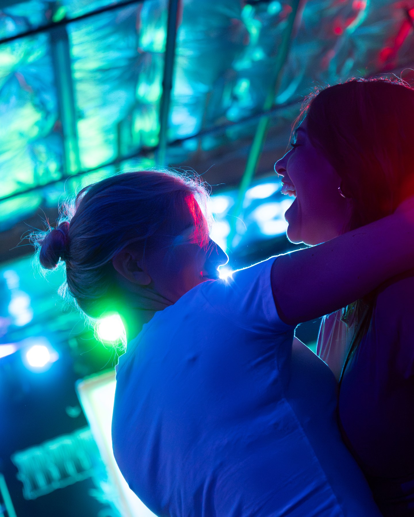 Guests interacting under green and blue lighting