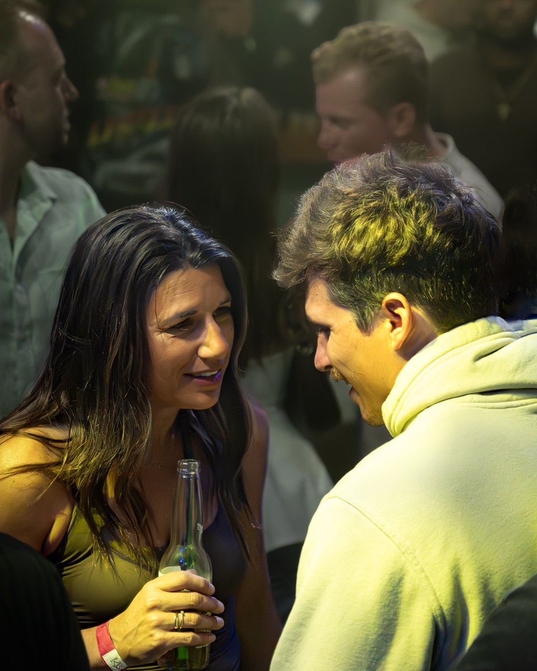 A guest cheering in a blue-lit club