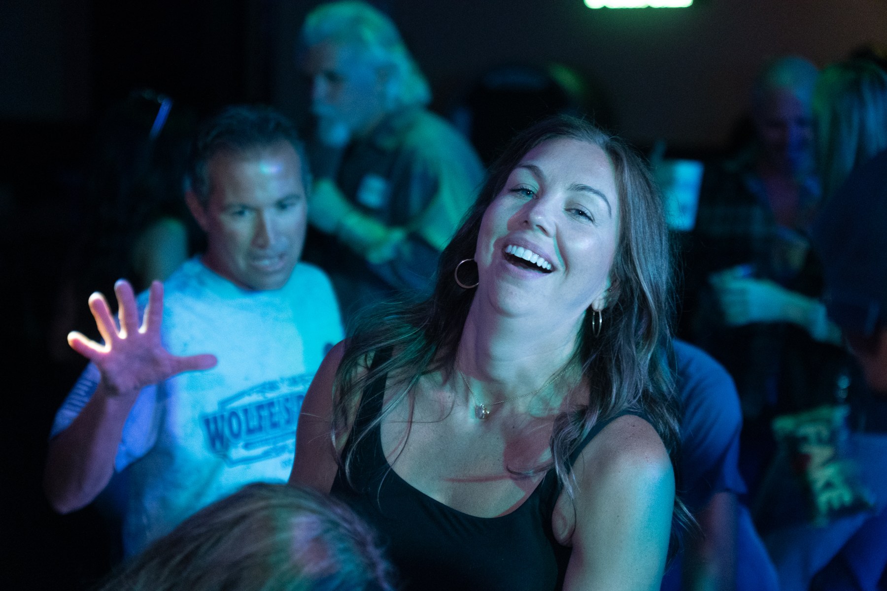A woman dancing with her arms out in a club