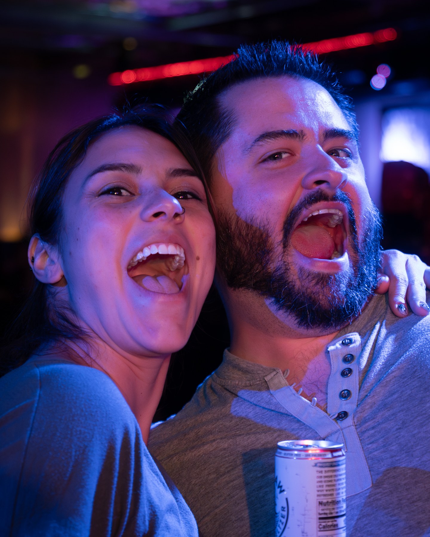 Two guests celebrating together under club lighting