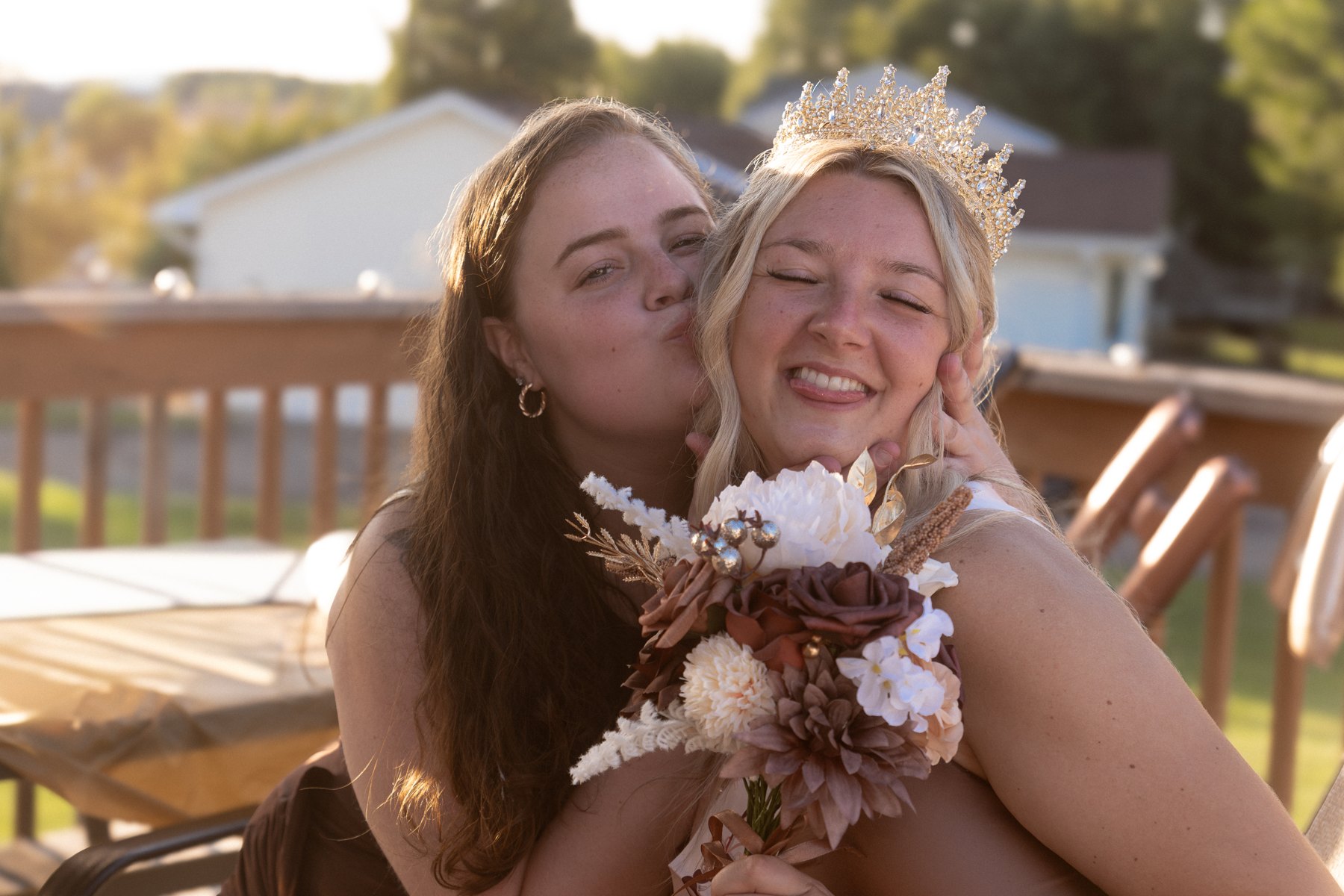 Two guests embracing on the patio during a birthday celebration