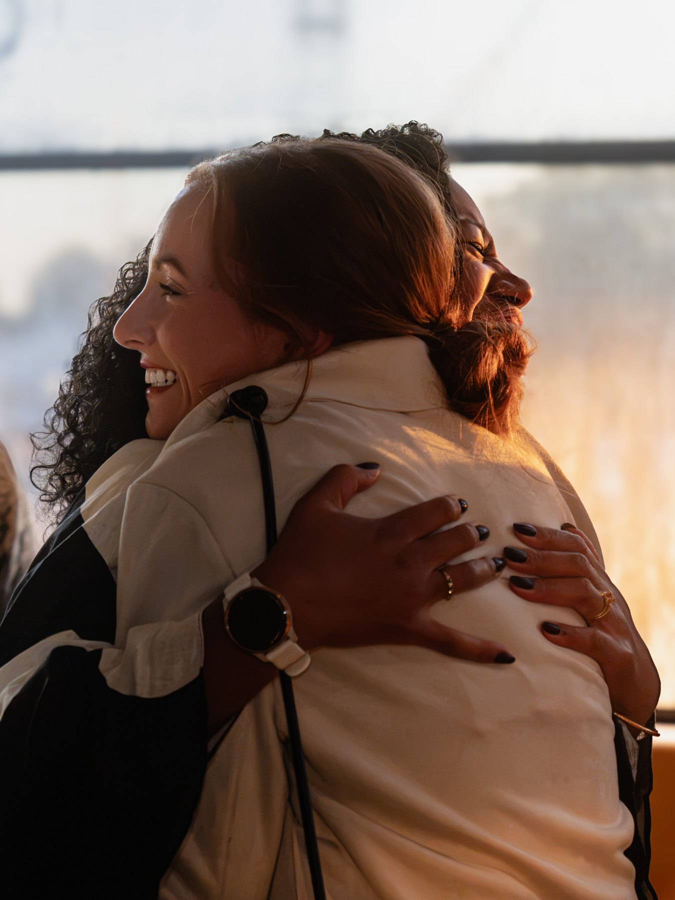 Two guests sharing a hug at a birthday celebration