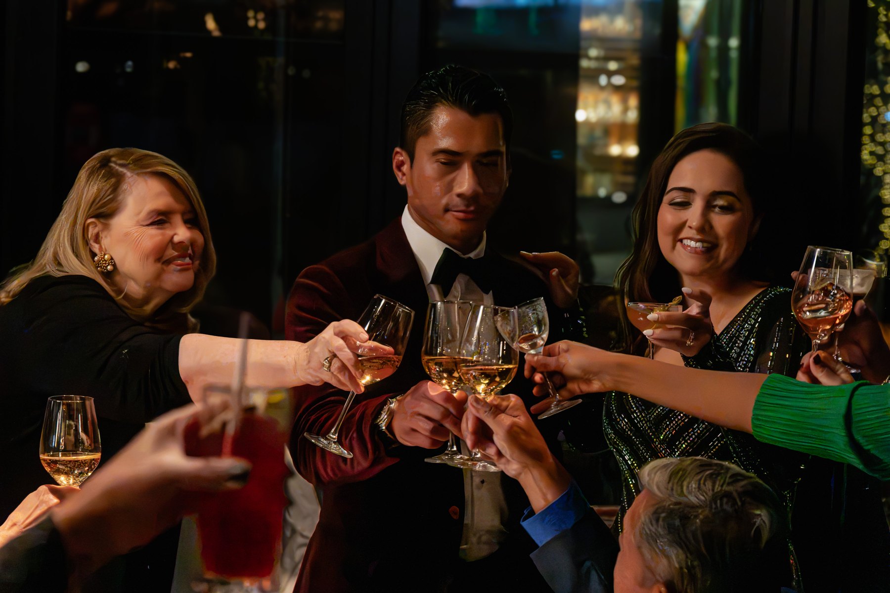Guests raising their glasses together at a birthday party
