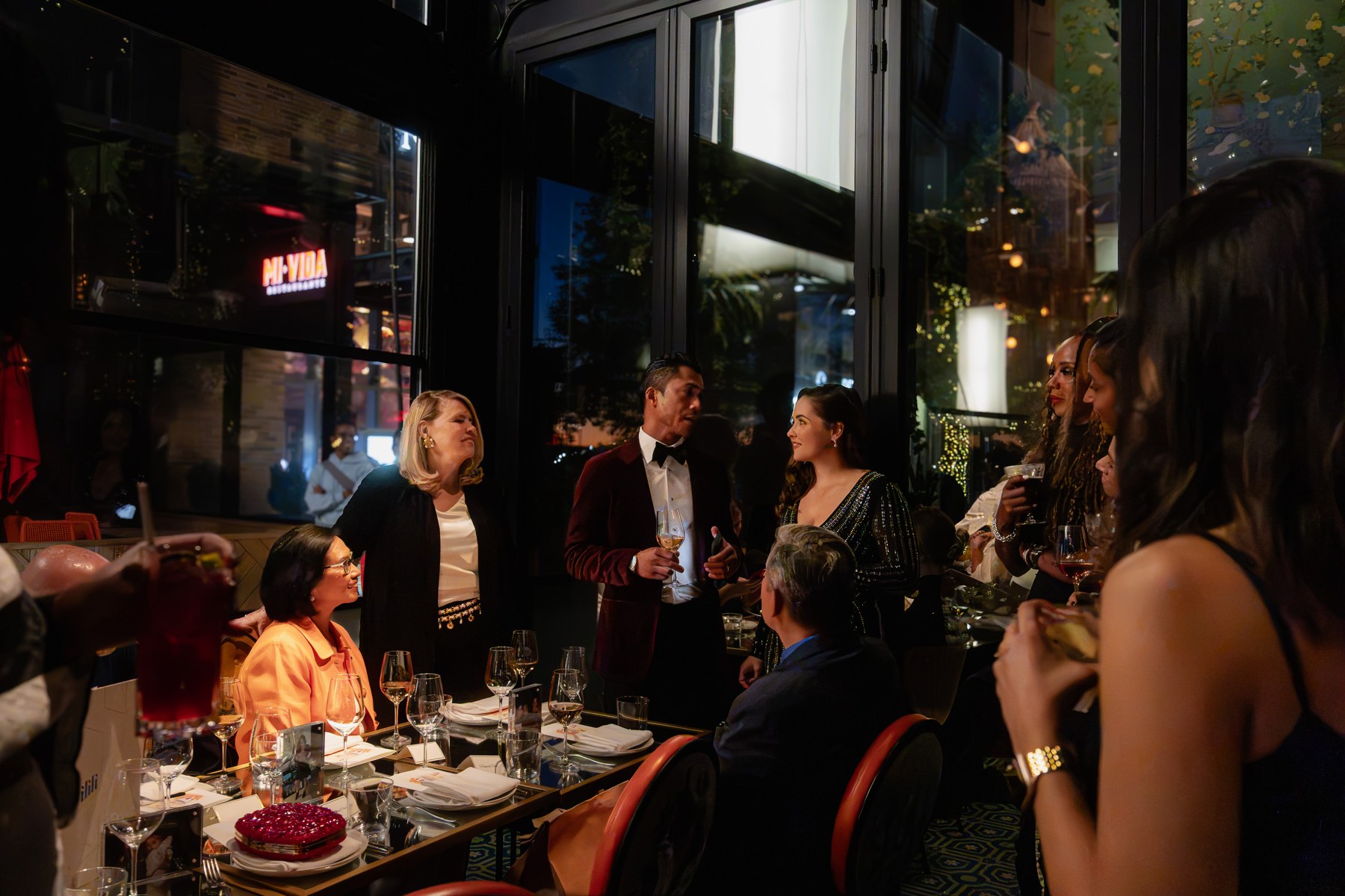 Birthday guests gathered around a dinner table during a toast in Washington, DC