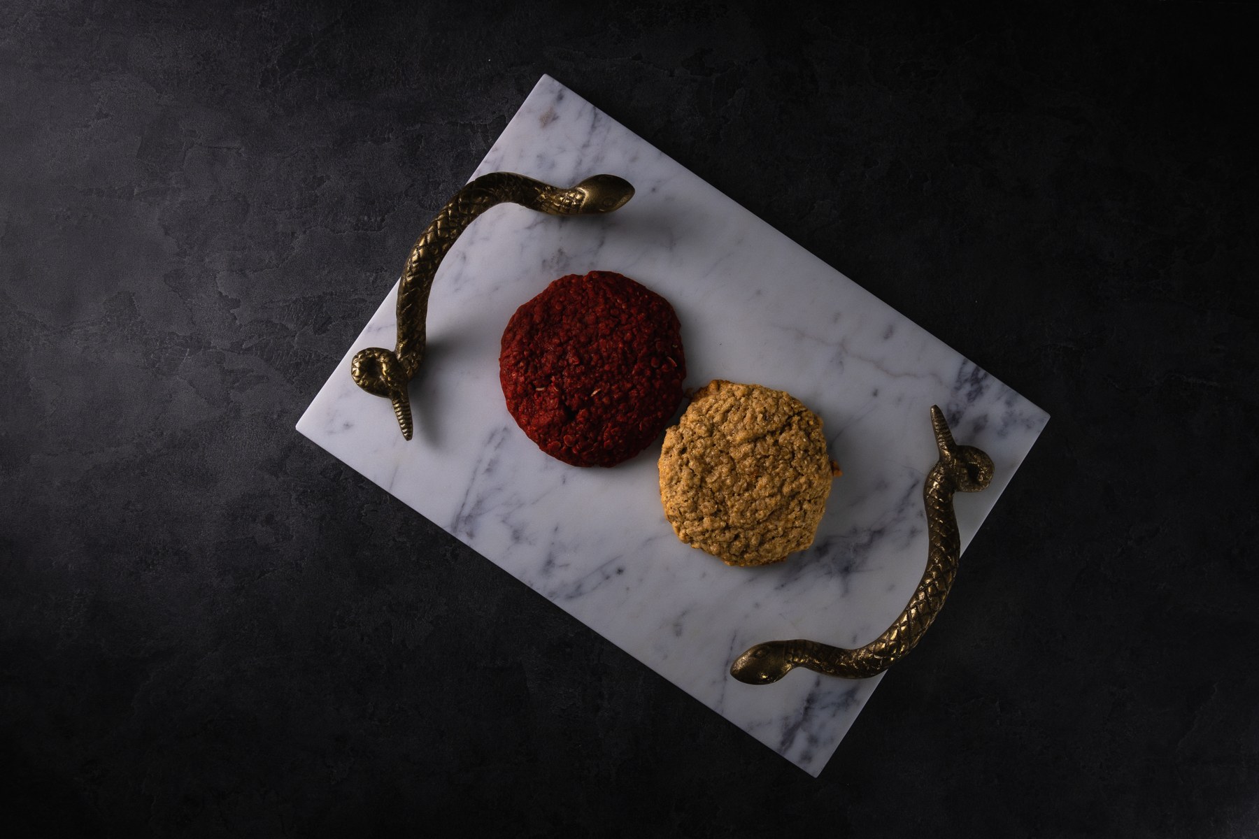 Colorful cookies arranged on a marble serving tray